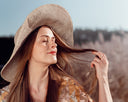 a woman with long hair wearing a hat